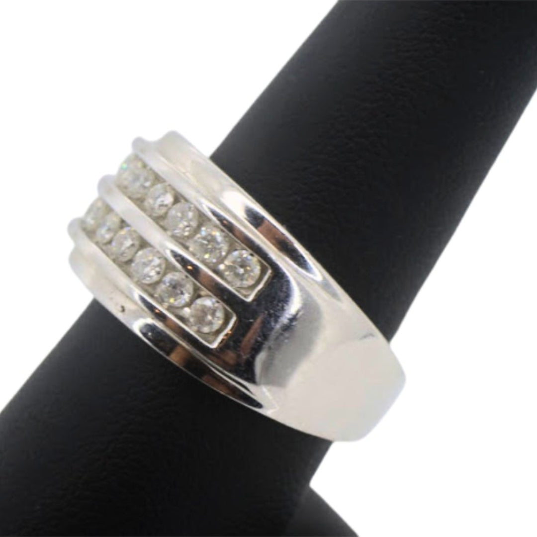 Silver ring with embedded stones on a black background