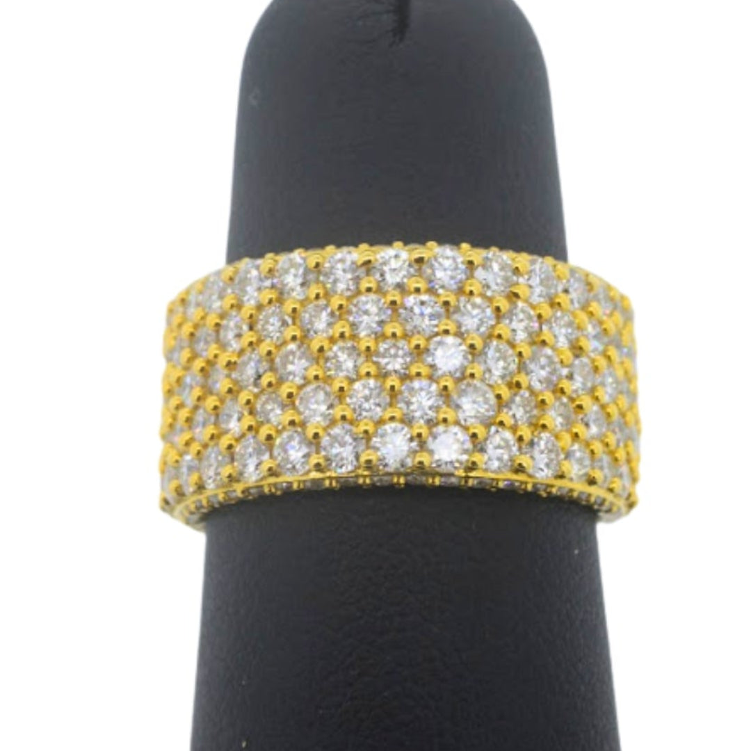 Gold and diamond bracelet on a black mannequin hand against a white background