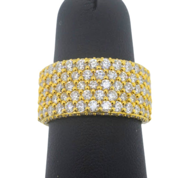 Gold and diamond bracelet on a black mannequin hand against a white background