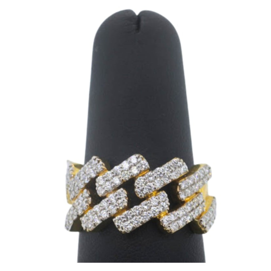 Gold and silver ring on a black stand against a white background