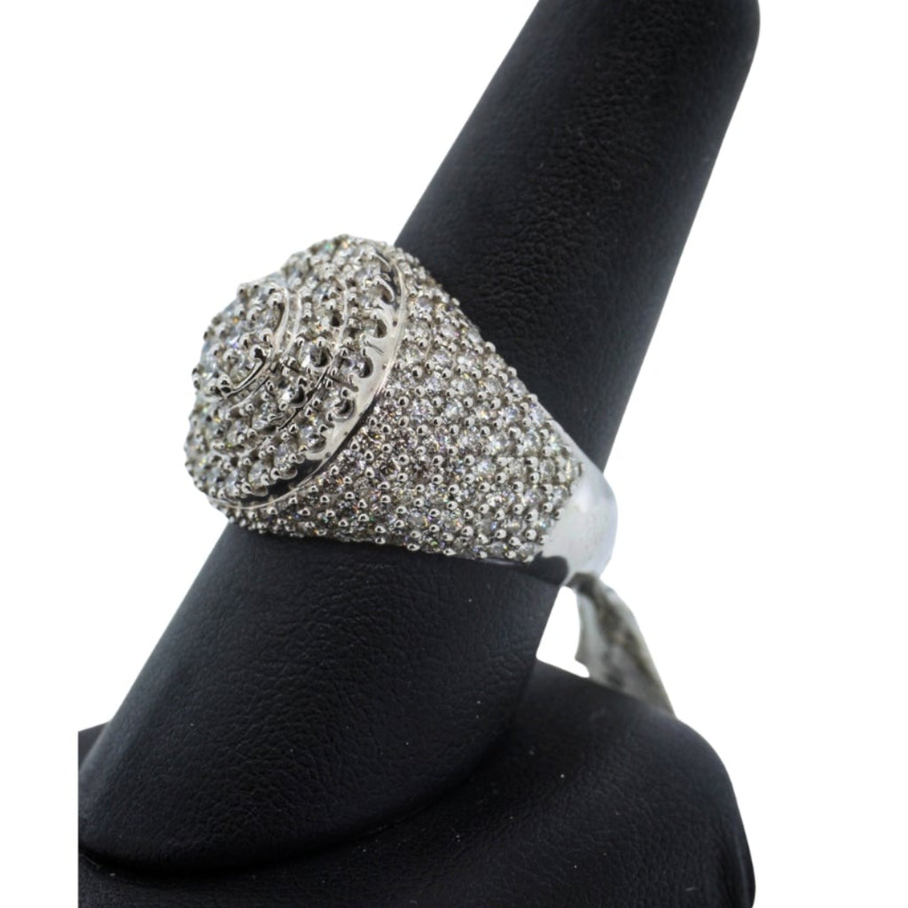 Silver ring with gemstones on a black stand against a white background