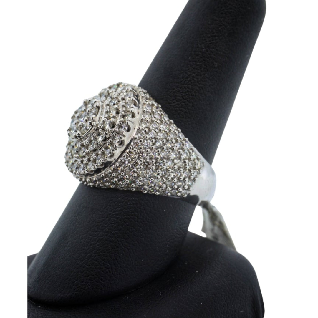 Silver ring with gemstones on a black stand against a white background