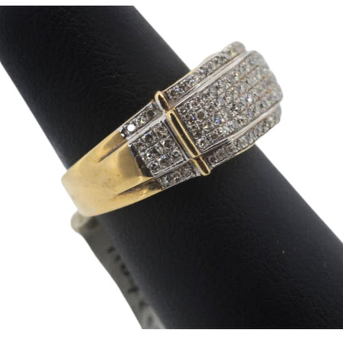 Gold and silver ring on a black cylindrical object with a white background