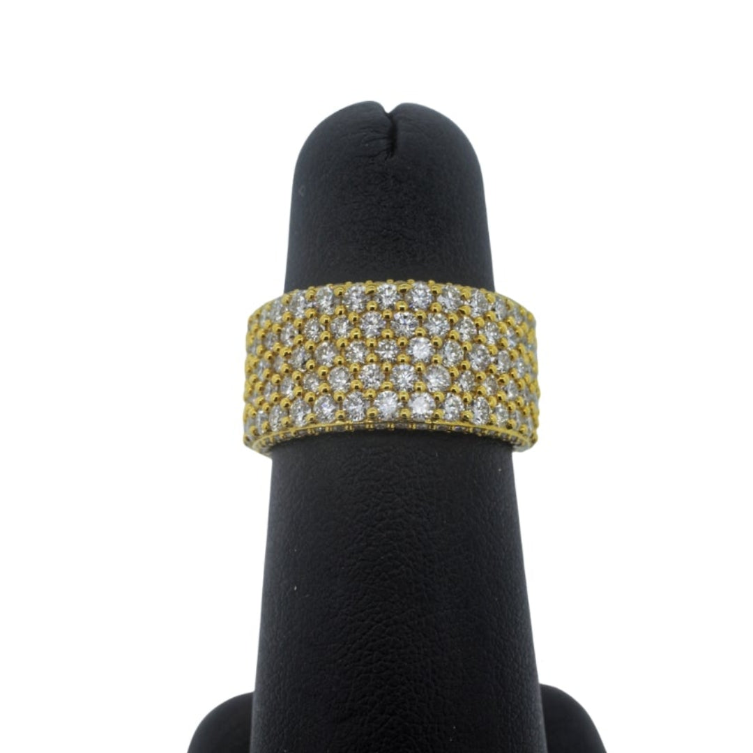 Gold bracelet on a black mannequin hand against a white background