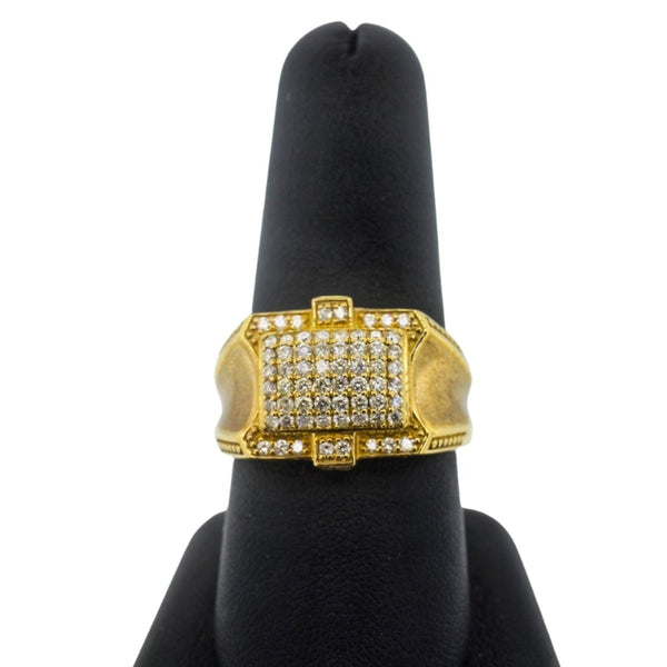 Gold ring with diamonds on a black stand against a white background
